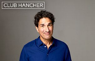 Gary Gulman weaking blue button down close-lipped smiling straight on at the camera. Club Hancher text treatment in upper left corner