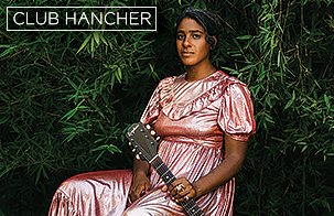 Leyla McCalla sitting in a pink dress against greenery holding her guitar to her left side. Club Hancher text treatment in upper left corner