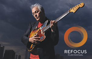 Marc Ribot playing guitar against a grey background. Refocus Fillm Festival logo in lower right corner