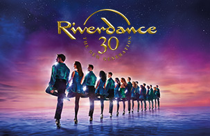 Riverdance banner photo: Dancers lined up with gold text Riverdance 30 