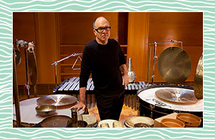 Steven Schick standing in front of percussion instruments