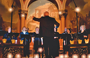 The Crossing Music Director Donald Nally with his back to the camera in motion conducting standing choir 